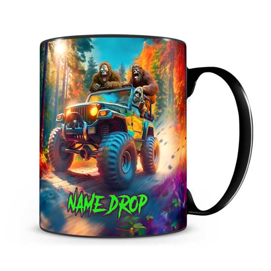 A black ceramic souvenir mug featuring a colorful full-wrap illustration of two Bigfoots driving a Jeep through an autumn forest with a green neon NAME DROP placeholder