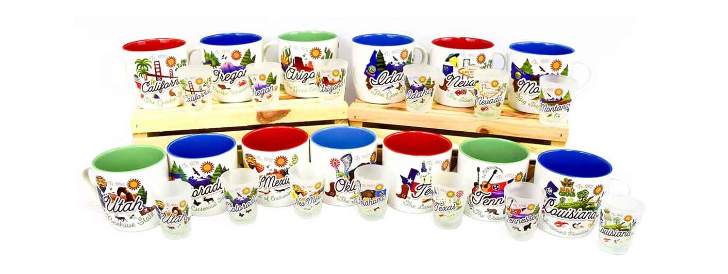 A wholesale display of custom state souvenirs, featuring colorful ceramic mugs and shot glasses