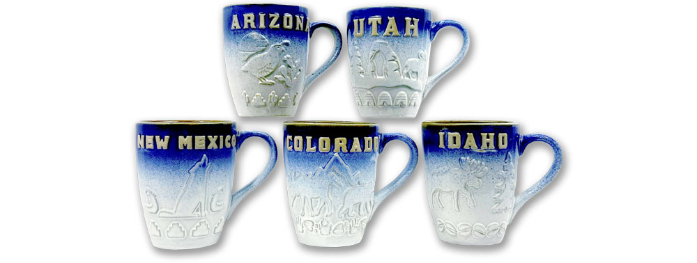 A wholesale collection of custom embossed ceramic mugs featuring raised-relief state names and landmarks for Arizona, Utah, New Mexico, Colorado, and Idaho with a blue dip glaze