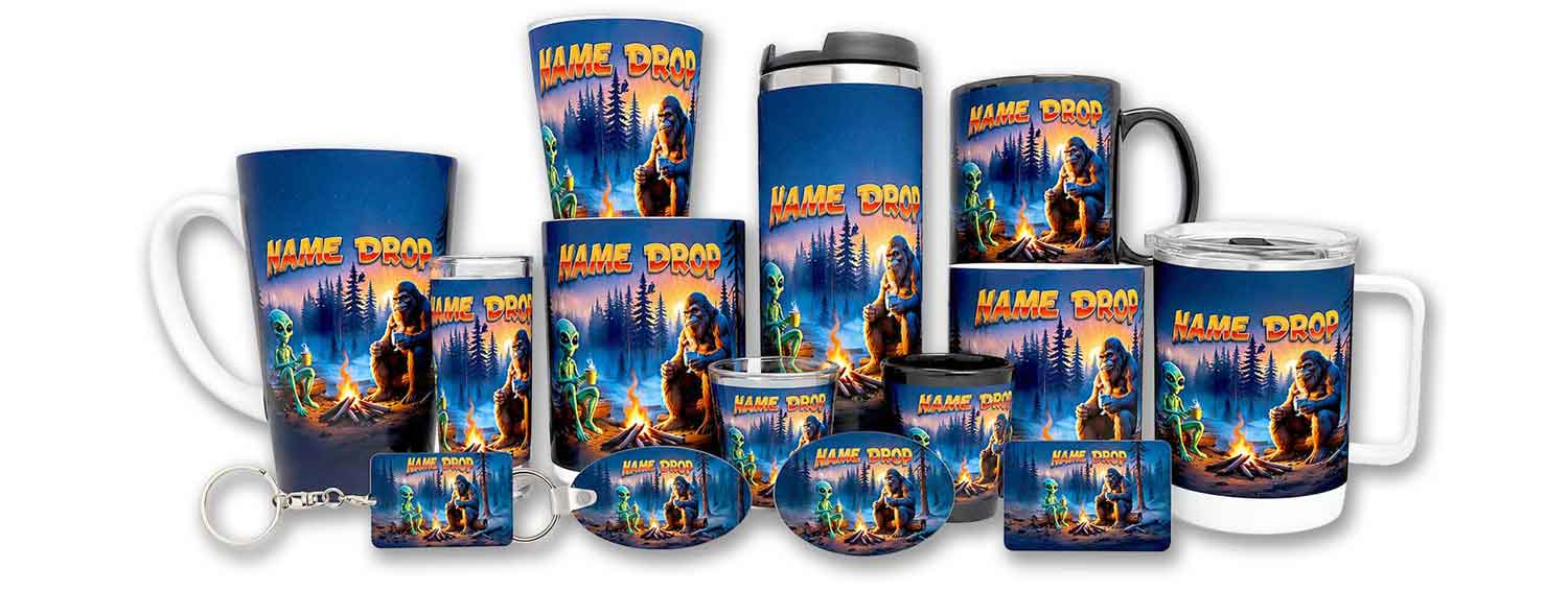 A wholesale collection of custom name-drop sublimated souvenirs including drinkware, keychains, and magnets featuring a campfire scene with Bigfoot and an alien