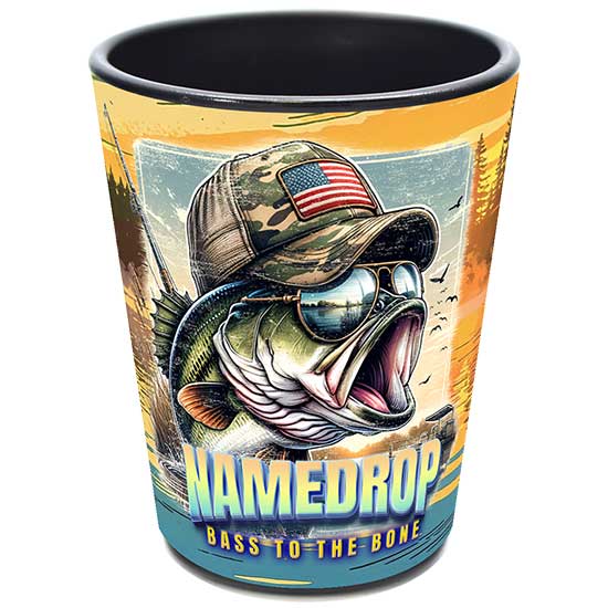 A sublimated ceramic shot glass featuring a colorful full-color illustration of a largemouth bass fish wearing sunglasses and a camo hat, with text reading NAMEDROP Bass To The Bone