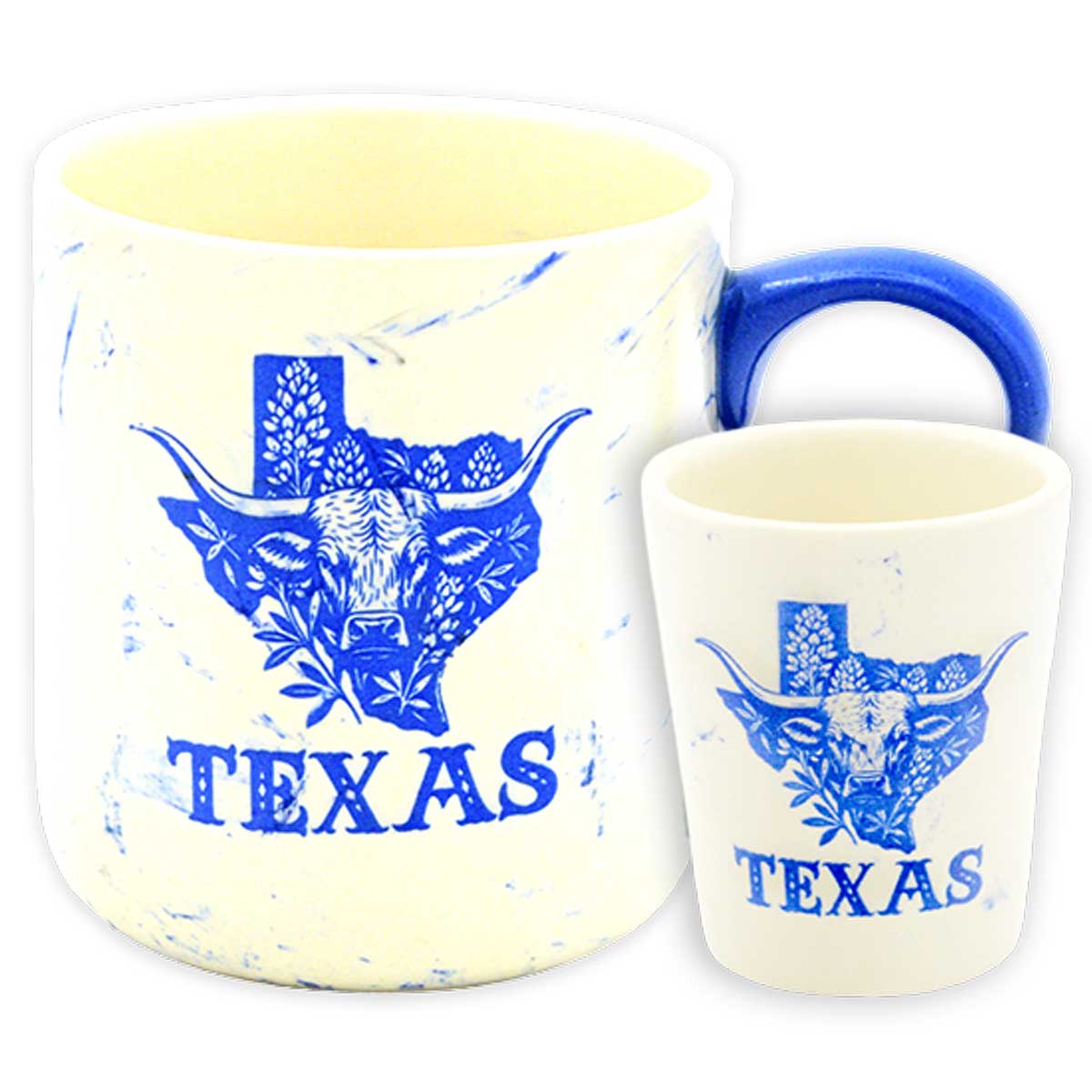 A wholesale souvenir set featuring a cream marble-textured ceramic mug and matching shot glass with blue Texas longhorn and state map graphics with bluebonnet flowers