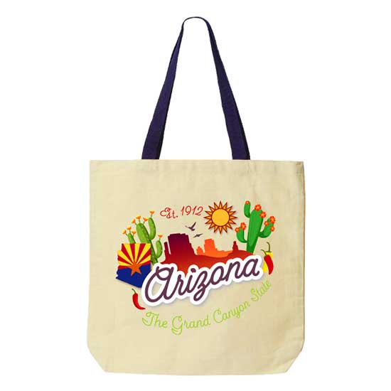 A souvenir cream colored canvas tote bag, featuring a custom printed Arizona landscape graphic with saguaro cacti, a state map