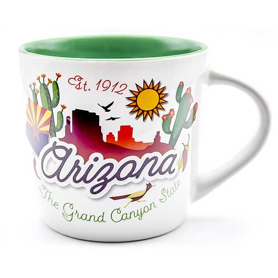 A wholesale white ceramic mug with a green interior glaze, featuring an embossed Arizona landscape graphic with saguaro cacti, red rock mesas, a roadrunner, and the text Est. 1912, Arizona, The Grand Canyon State